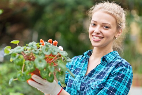 Gardeners working safely with tools in an outdoor setting